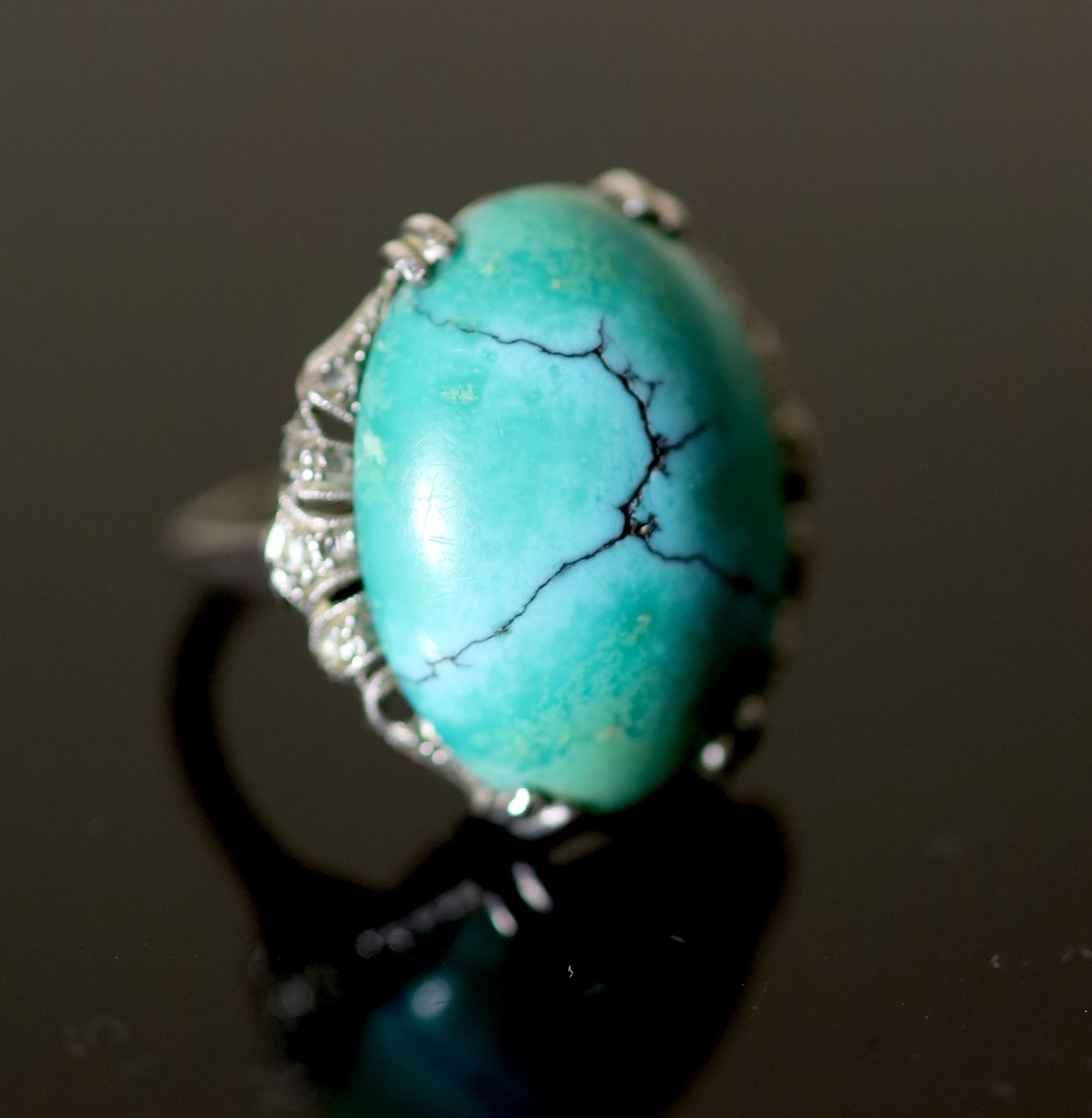 A 20th century 18k white gold, cabochon turquoise and rose cut diamond chip set oval dress ring,